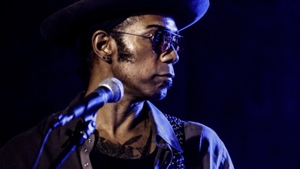 Al Berry performing on stage at a microphone
